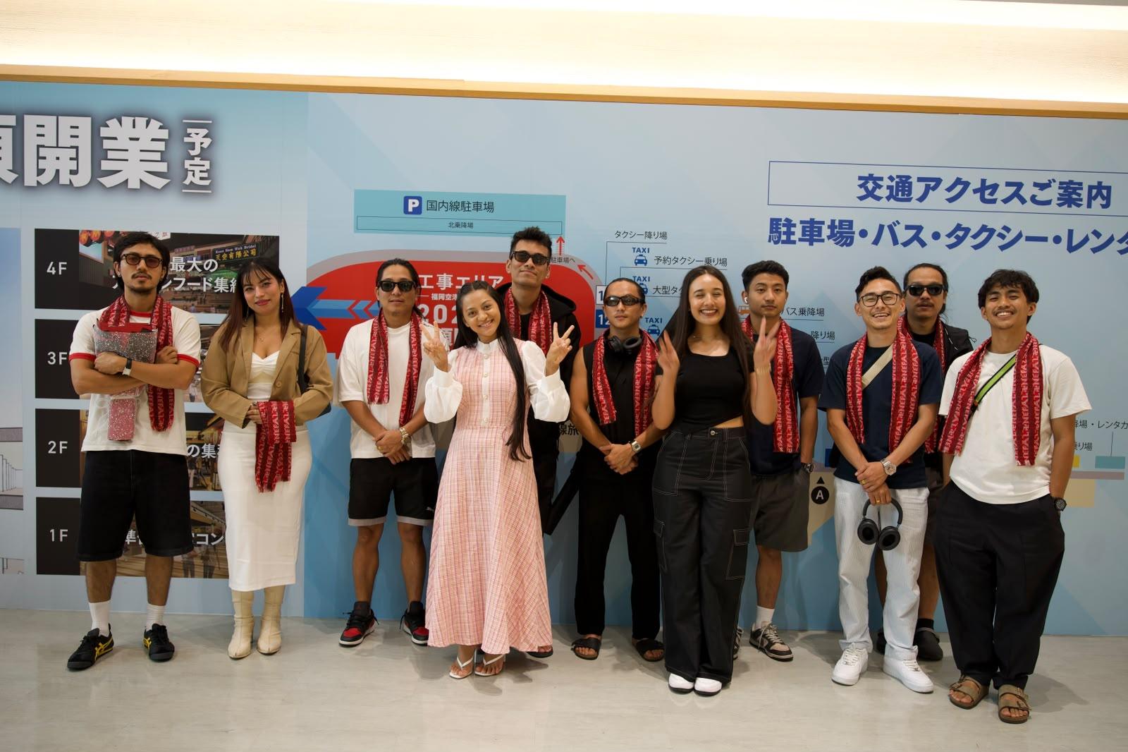 A group of Nepali travellers in red NEPAL scarves at Fukuoka Airport