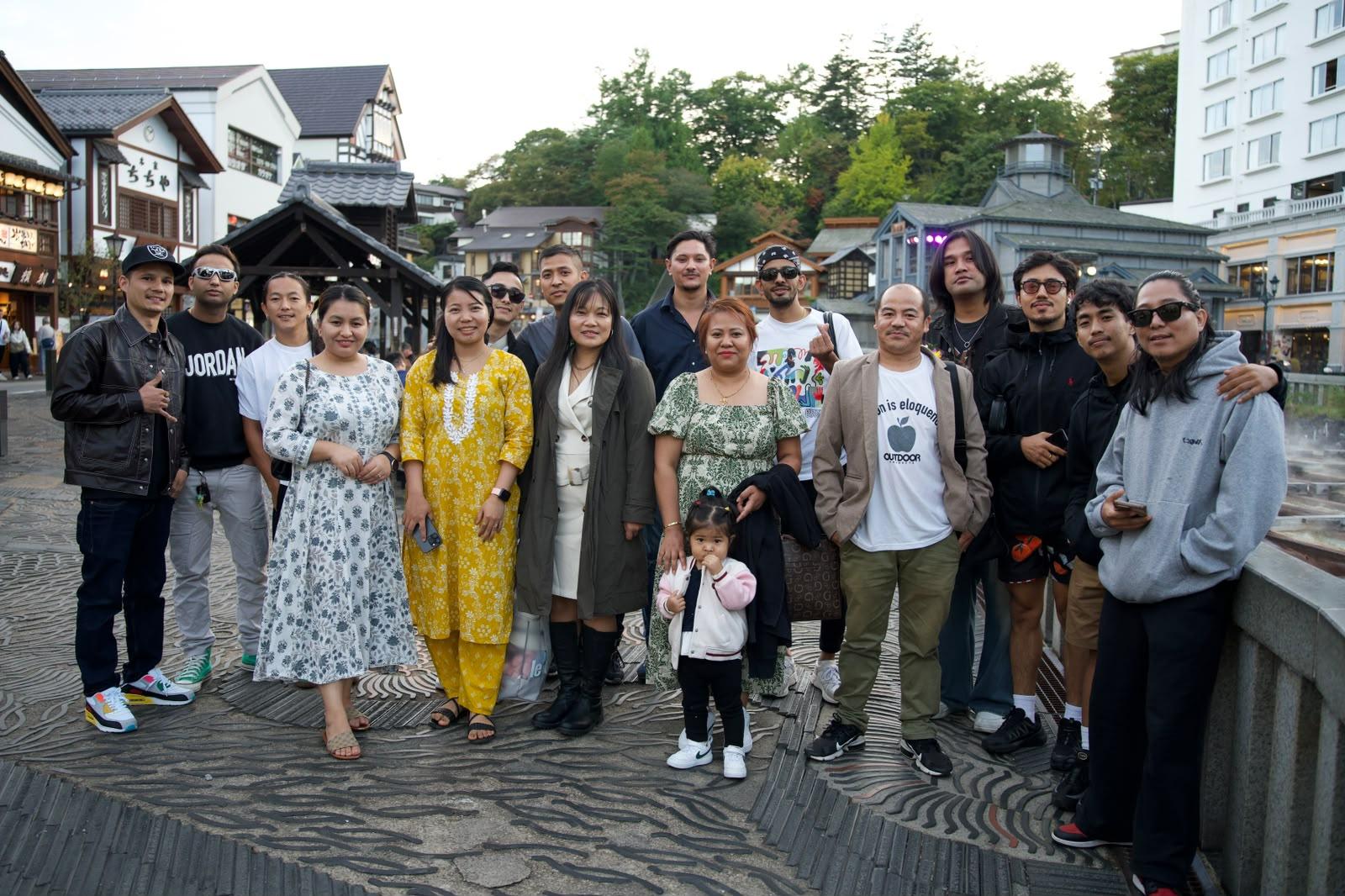A large group standing by the Yubatake hot spring field at Kusatsu Onsen